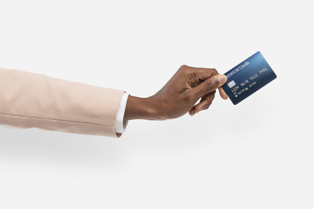 Credit card finance held by a hand for banking campaign